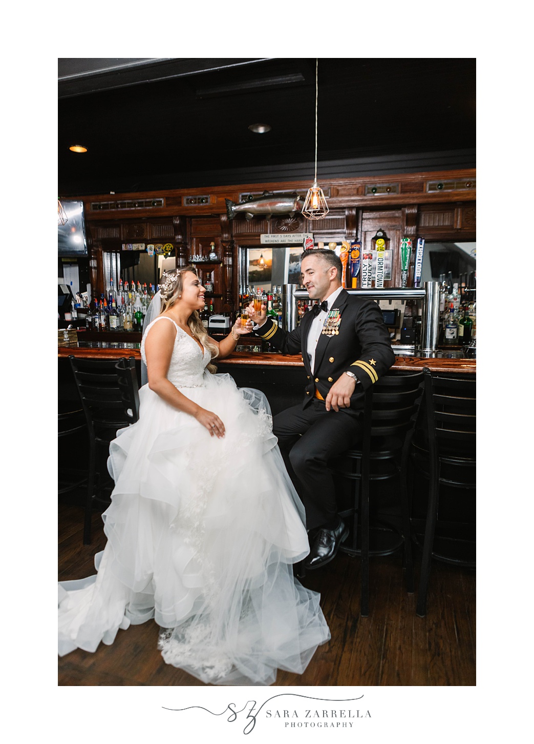newlyweds laugh at the bar in Newport Navy Officers’ Club