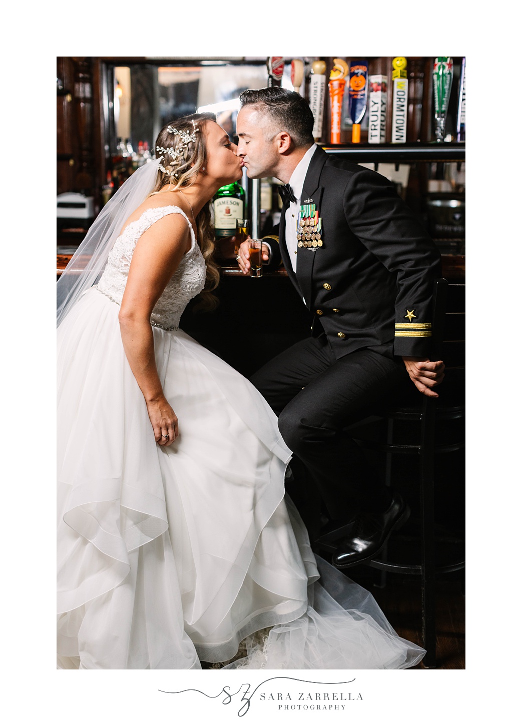 bride and groom kiss in bar at Newport Navy Officers’ Club