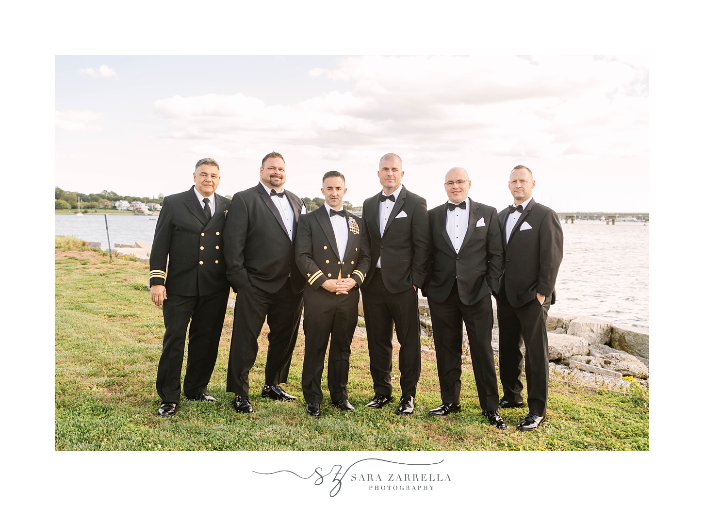 groom and groomsmen pose along waterfront in Newport RI