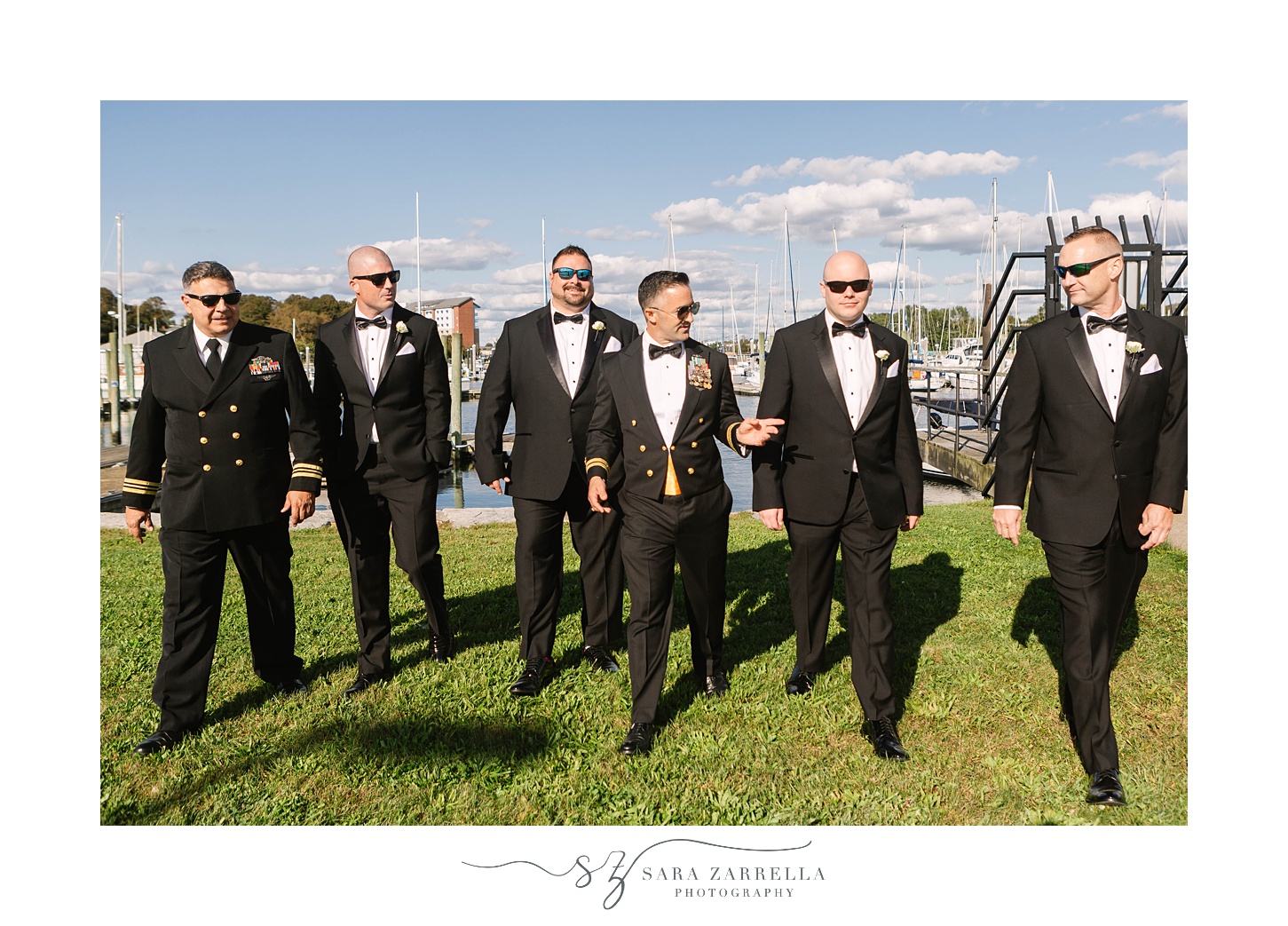 groom walks with groomsmen in sunglasses outside the Newport Navy Officers’ Club