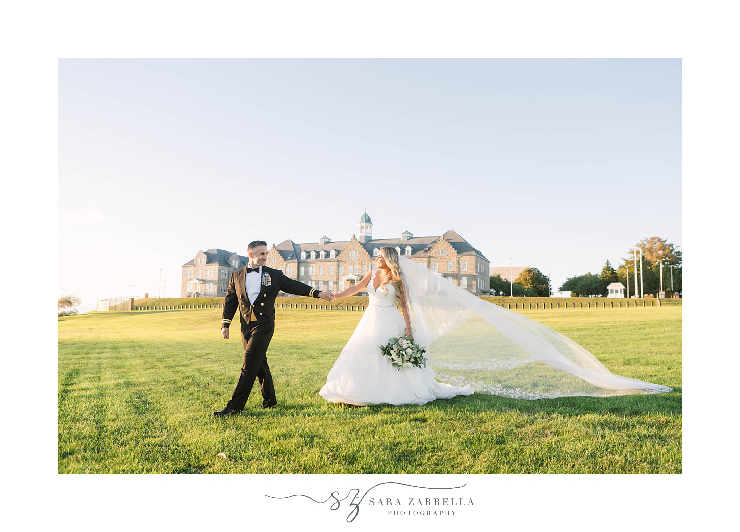 groom leads bride through lawn at the Newport Navy Officers’ Club