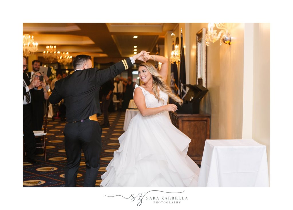 groom twilrs bride around before entering wedding reception at Newport Navy Officers’ Club