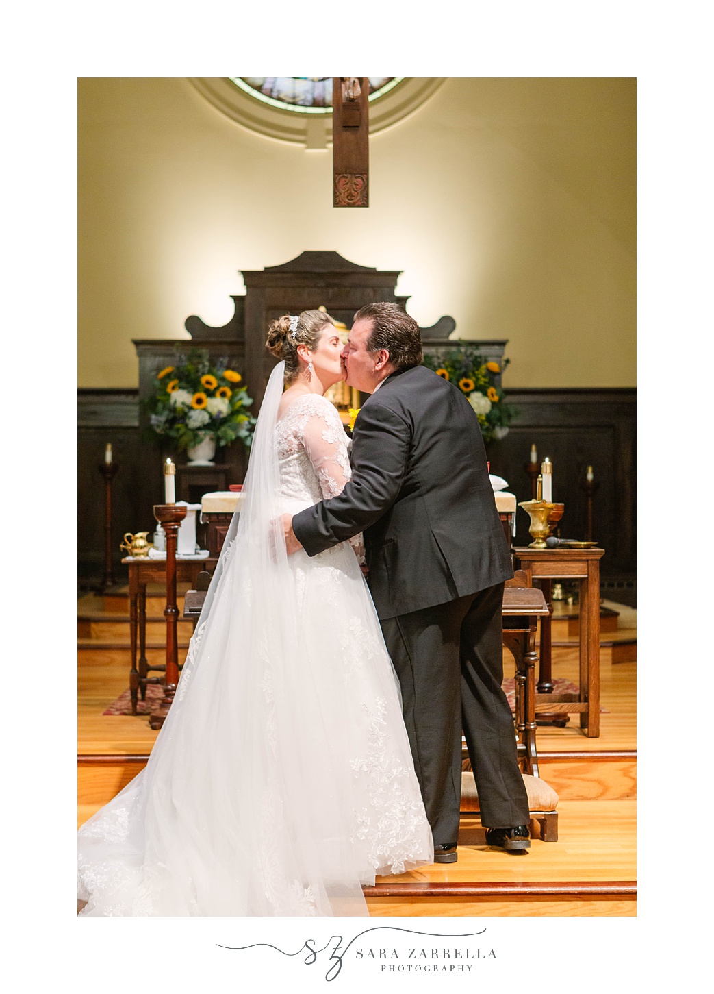 bride and groom kiss during traditional church wedding in Rhode Island