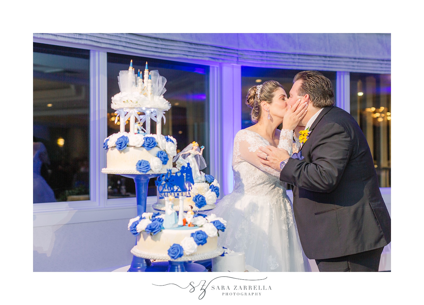 couple kisses after cutting cake at North Kingstown RI wedding reception