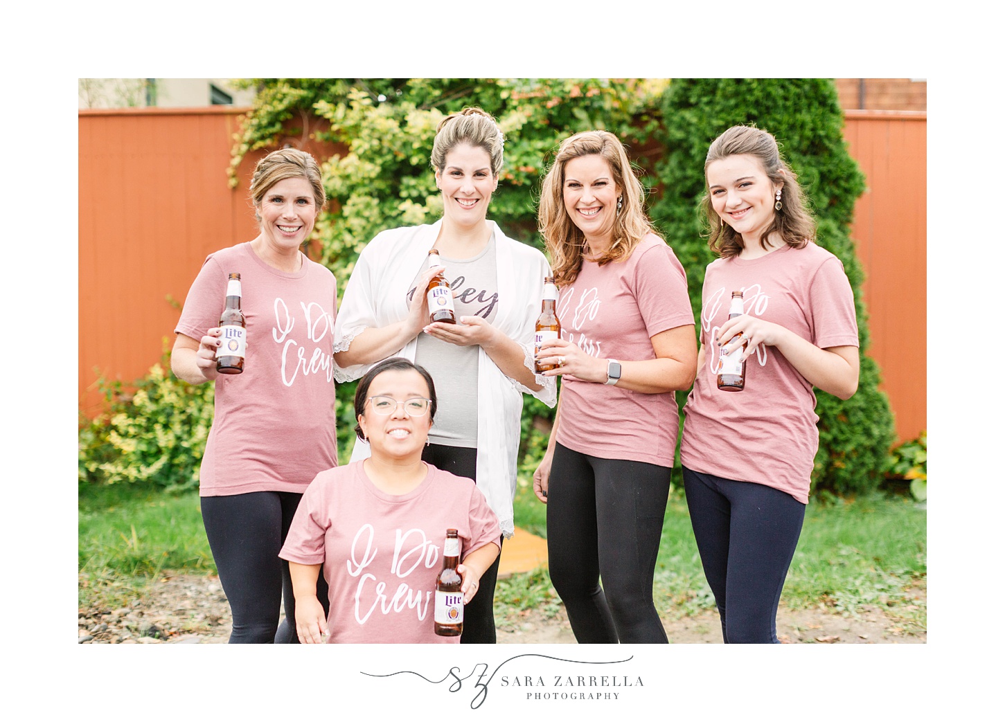 bride poses with bridesmaids in matching t-shirts