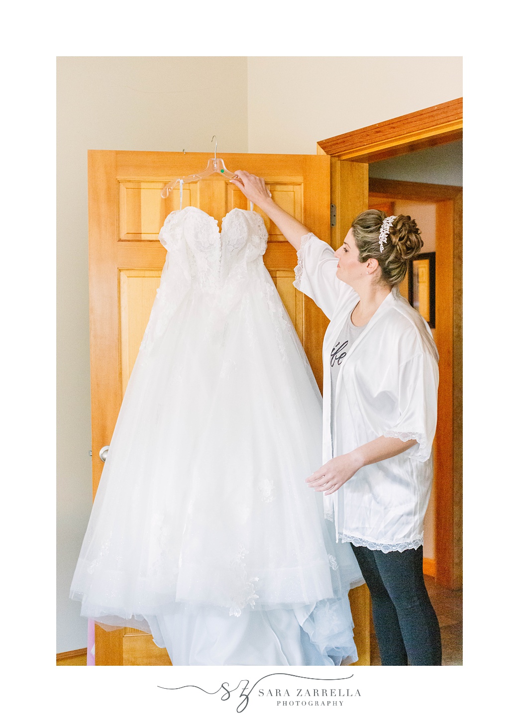 bride hangs wedding gown at Quidnessett Country Club
