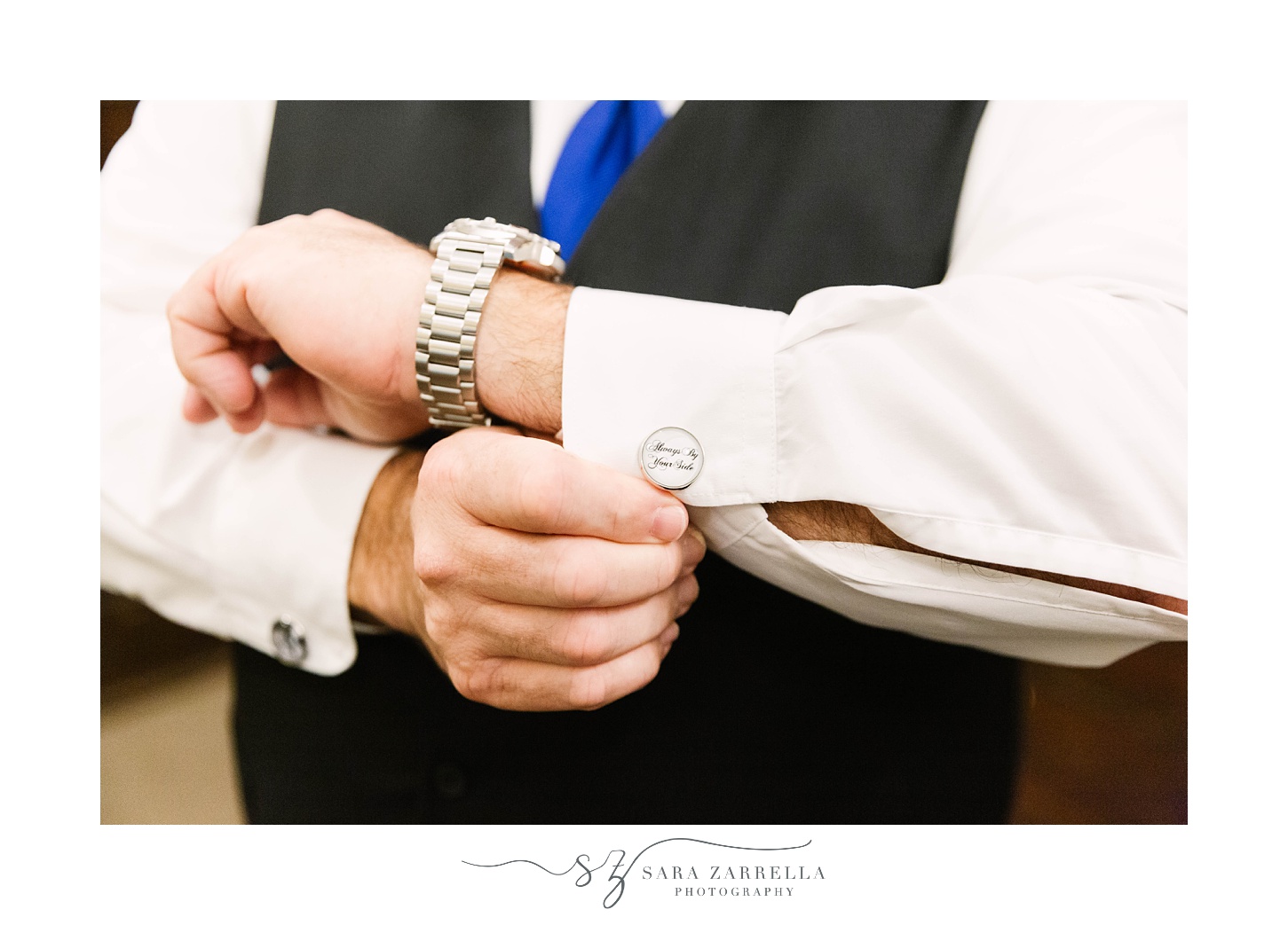 groom adjusts cufflinks before Quidnessett Country Club wedding day