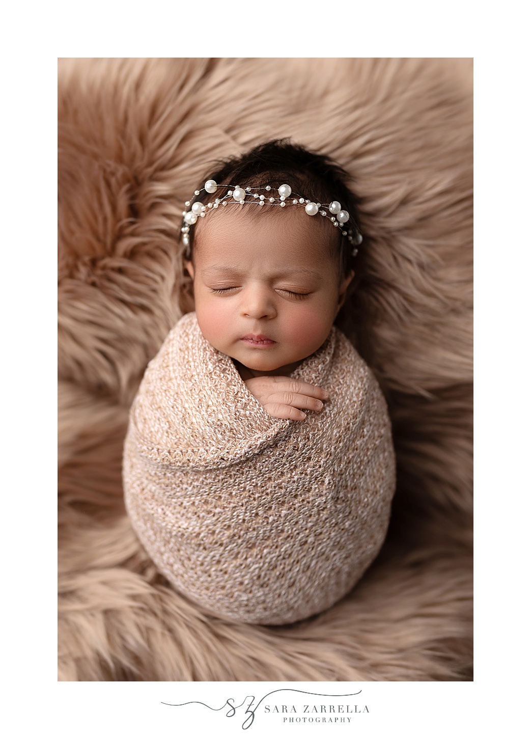 baby girl sleeps wrapped up during newborn portraits in RI studio