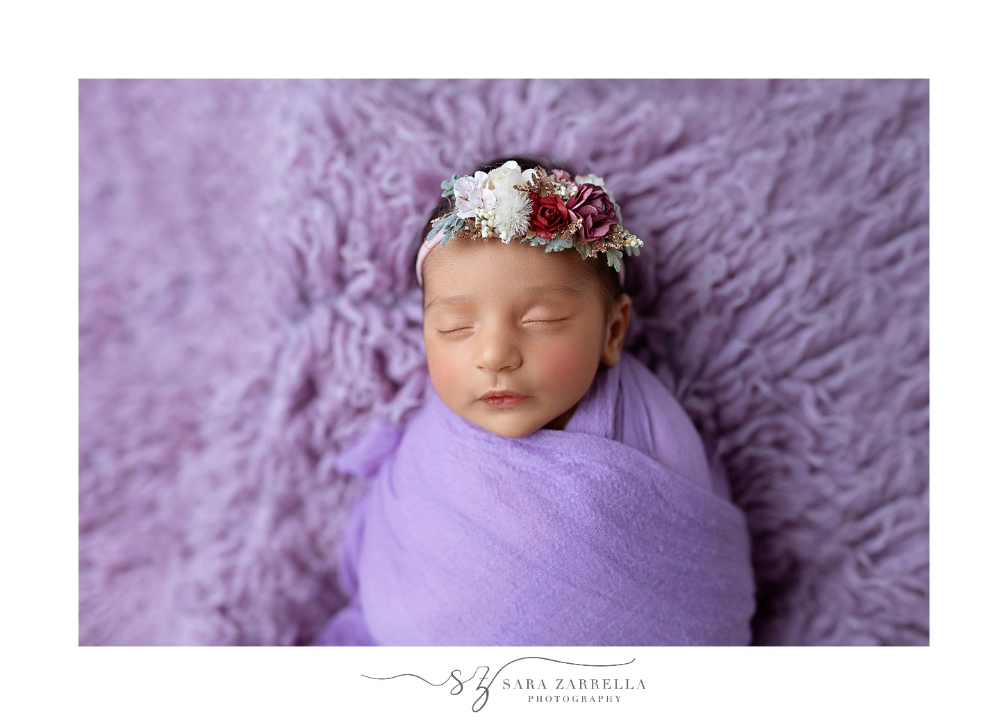 baby sleeps on purple backdrop