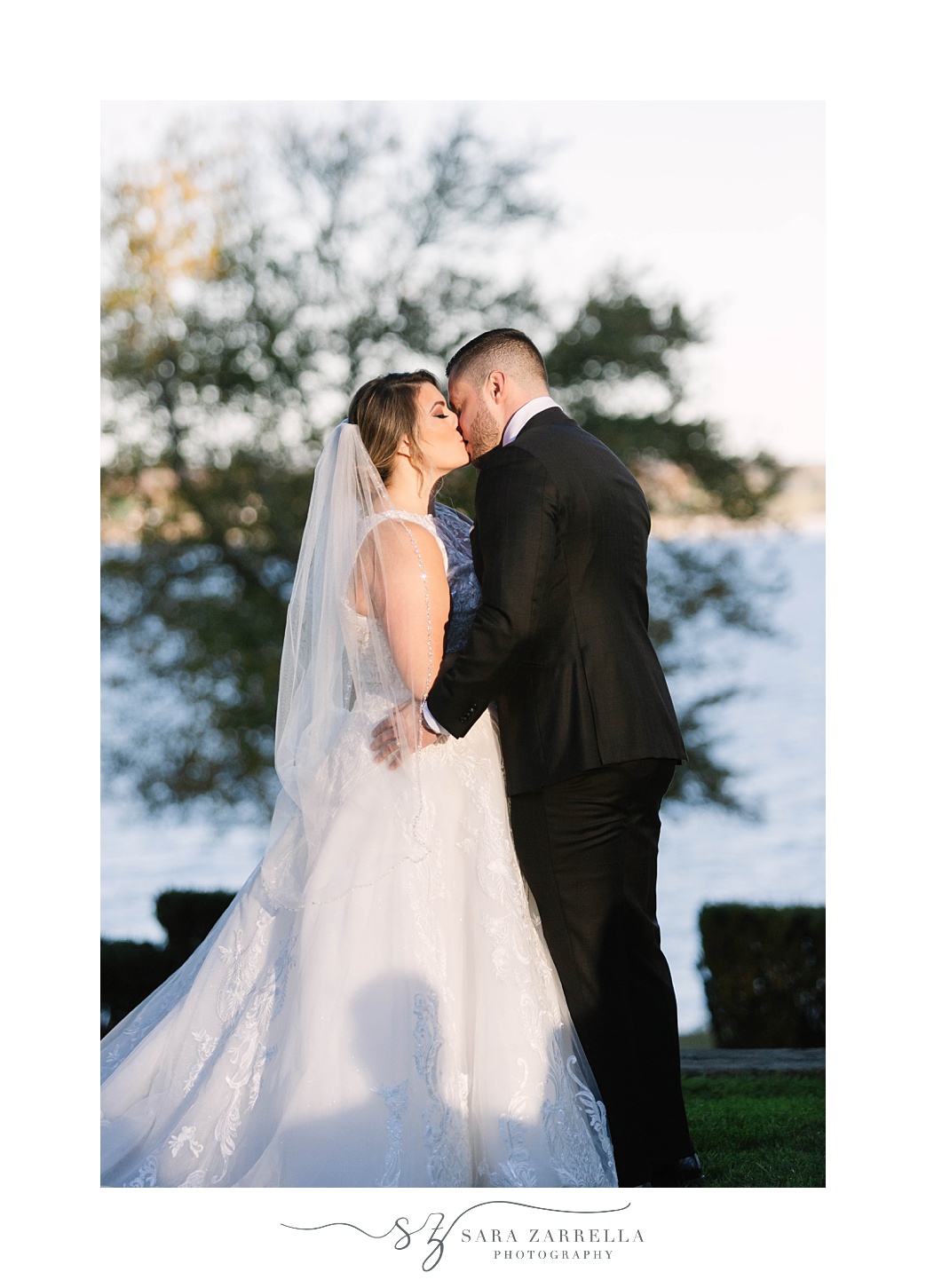 newlyweds kiss during classic waterfront wedding ceremony at Glen Manor House