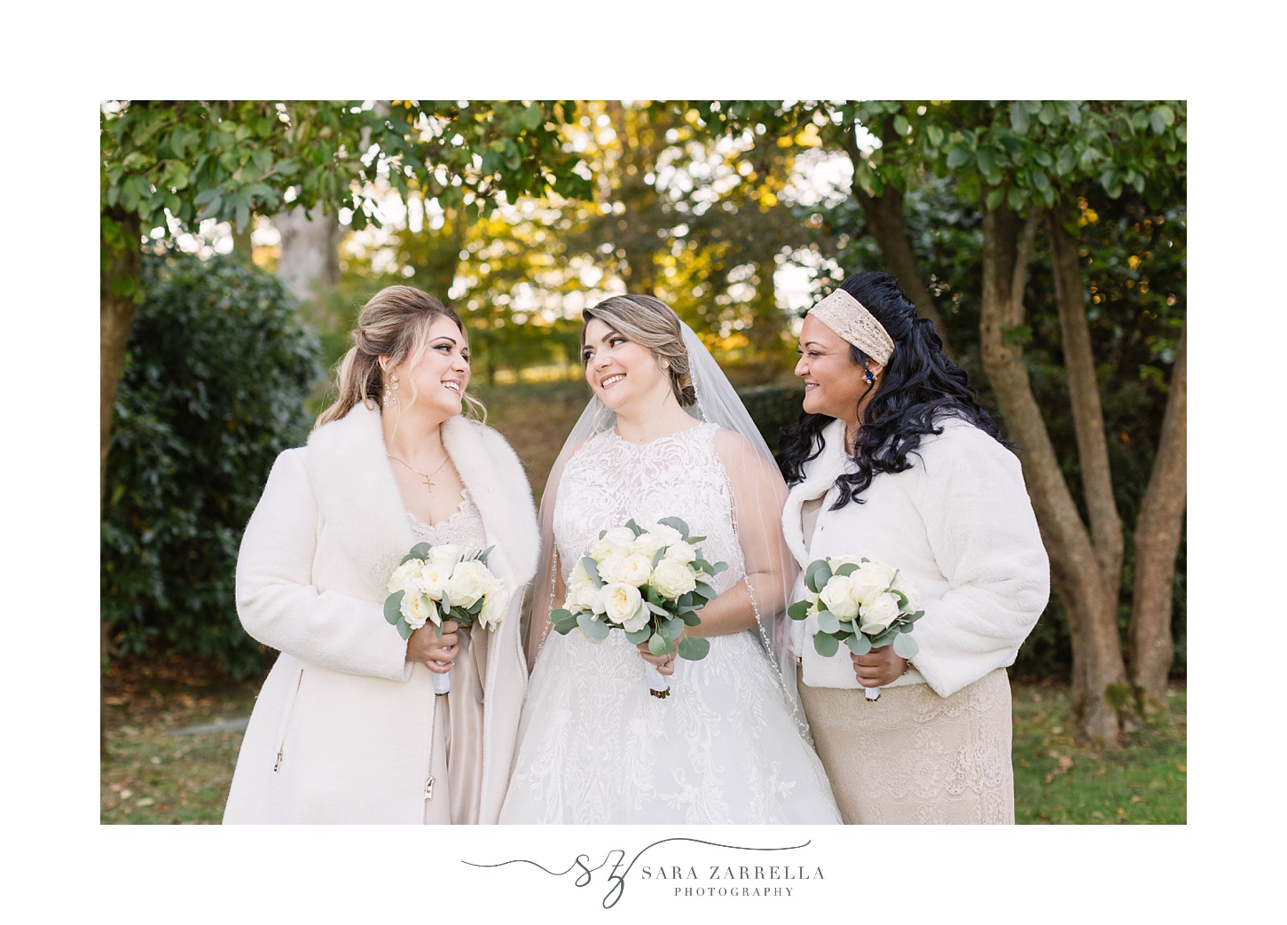 bride smiles with bridesmaids in mismatched gowns