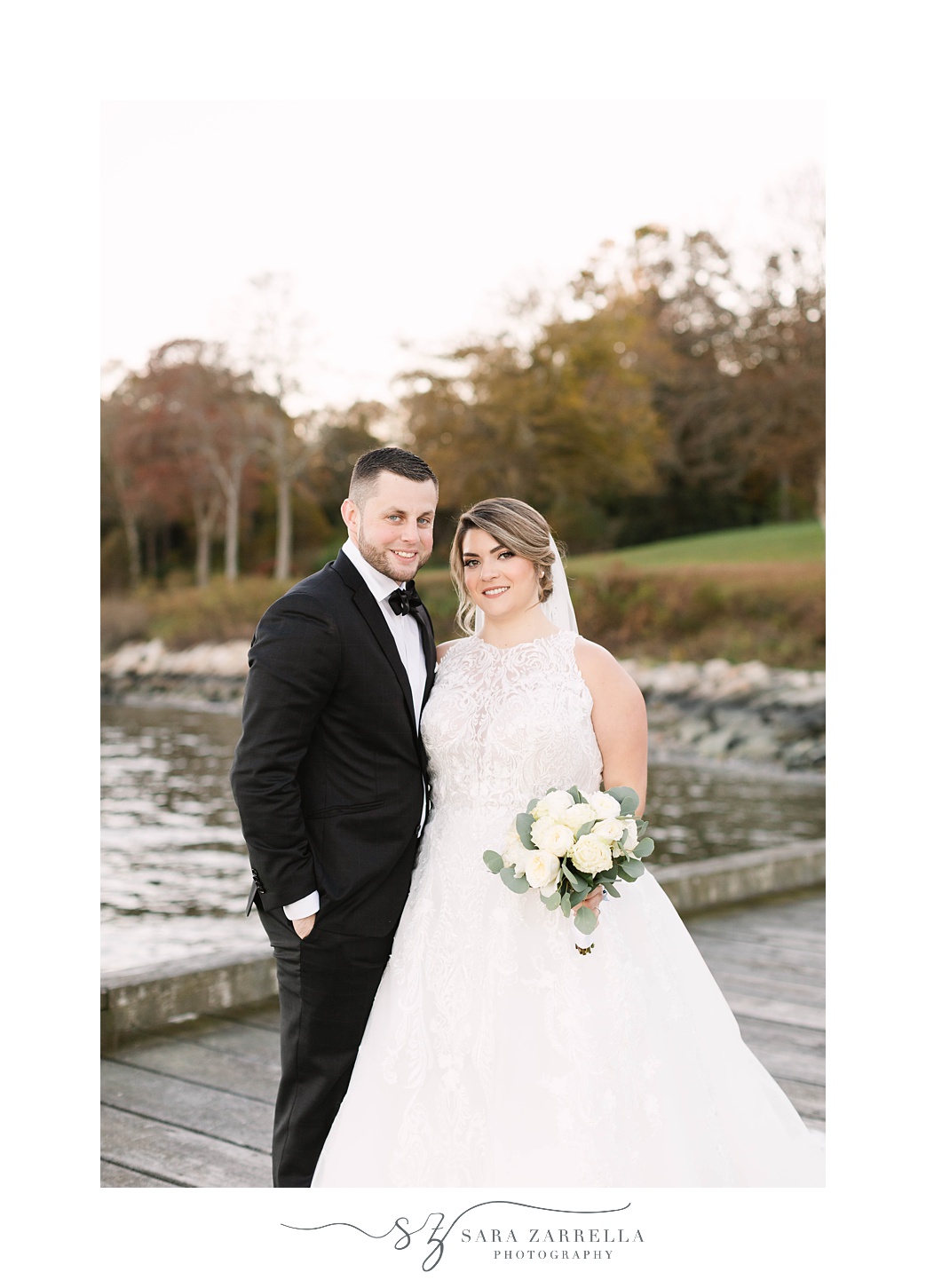 bride and groom stand together on wooden pier at Glen Manor House