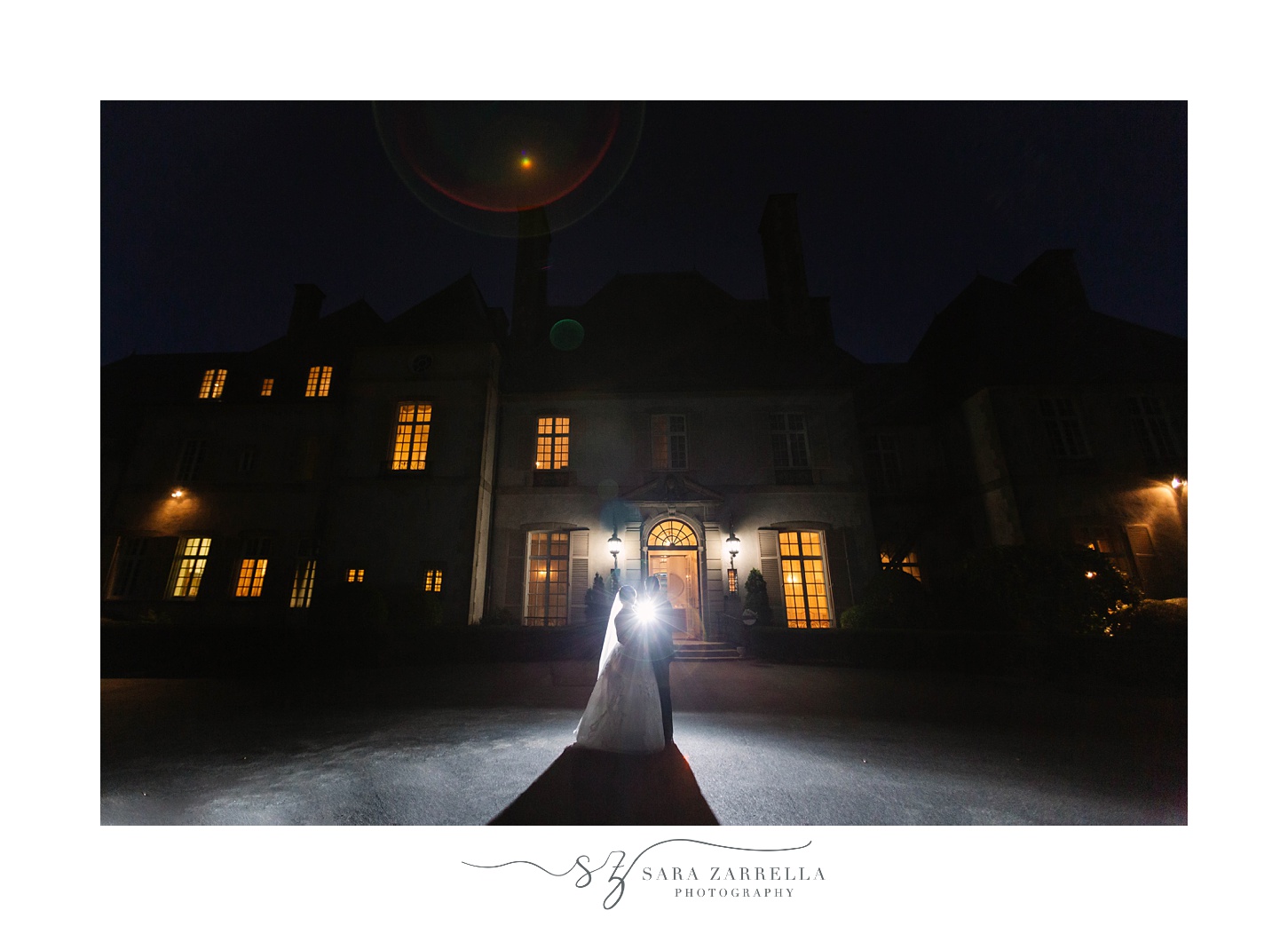 bride and groom kiss outside Glen Manor House at night