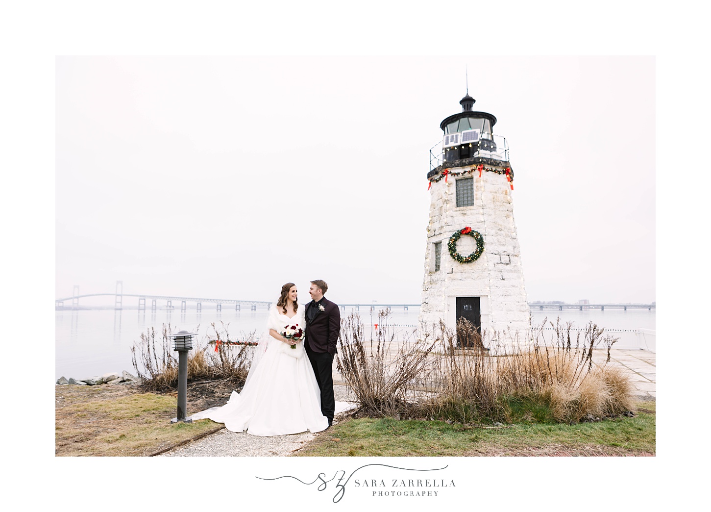 bride and groom stand by lighthouse at Belle Mer