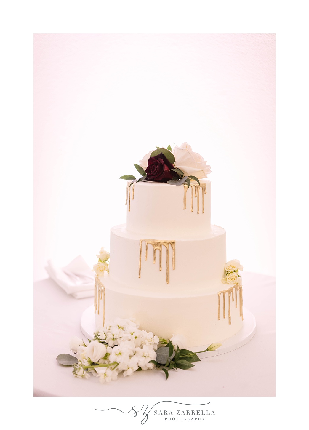tiered wedding cake with gold drip icing