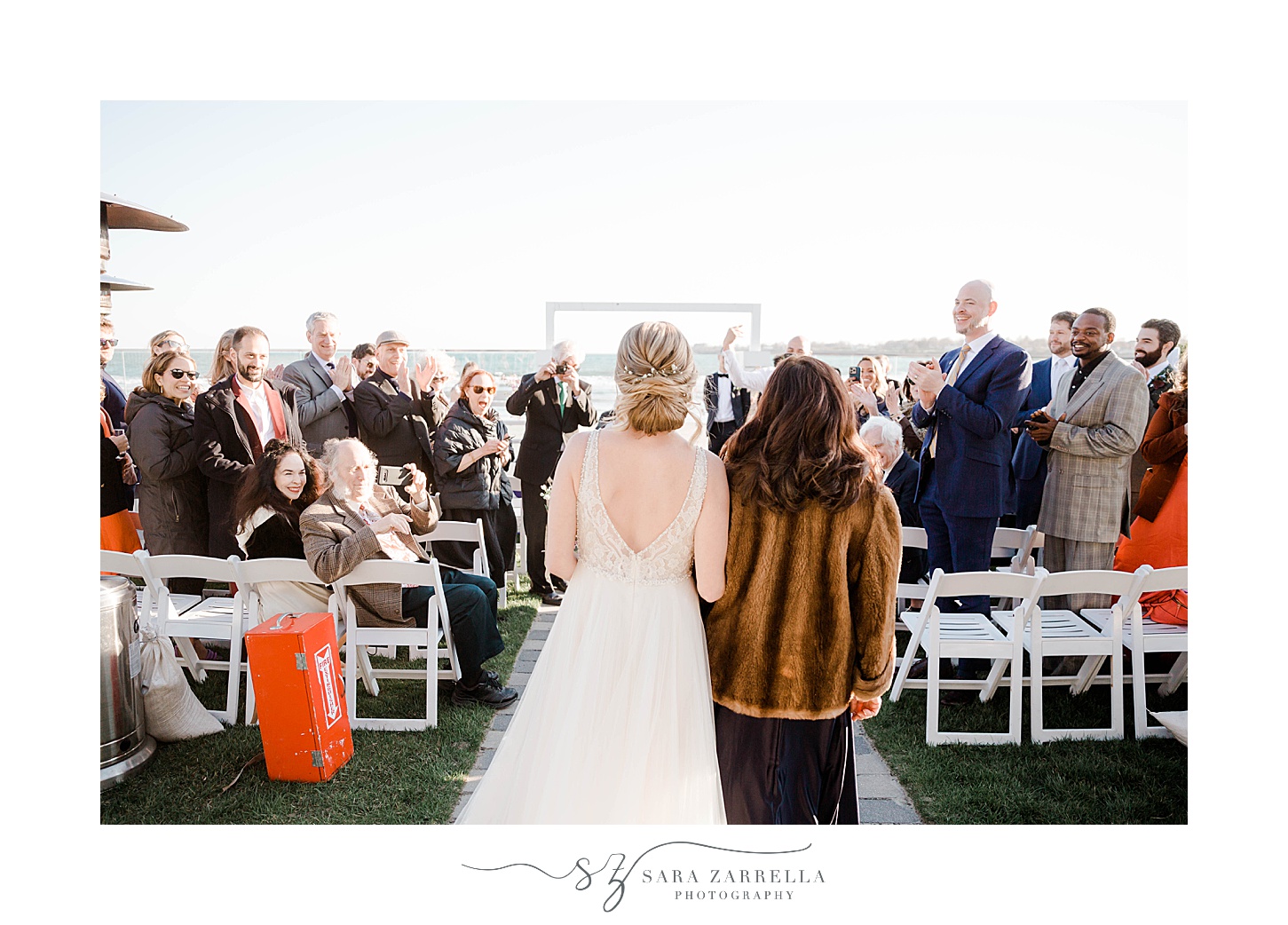 bride and mother walk down aisle together for Newport Beach House wedding ceremony