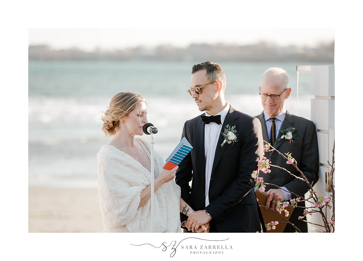 bride looks at groom during waterfront wedding ceremony
