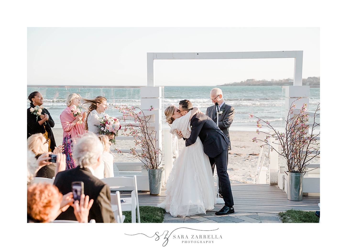 couple kisses during Newport Beach House wedding ceremony