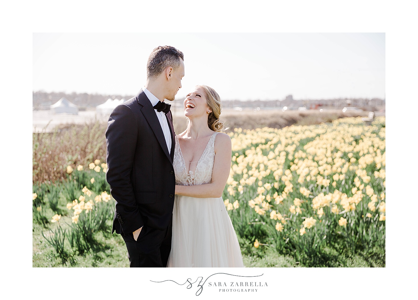 bride smiles up at groom in daffodil field