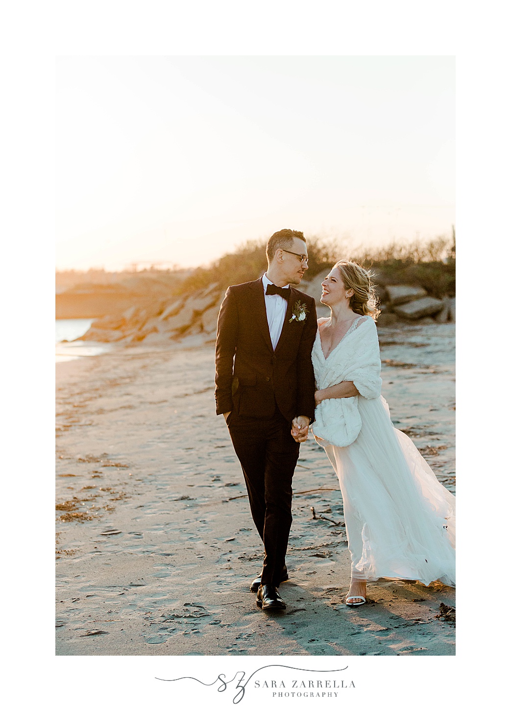 bride and groom smile together during sunset beach photos in Newport RI