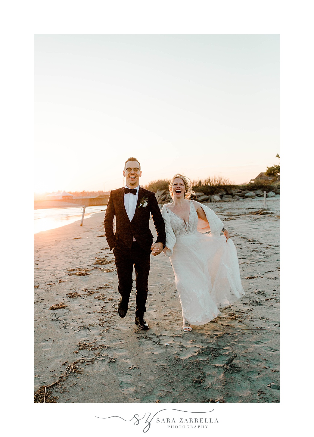 newlyweds run on beach in Newport RI