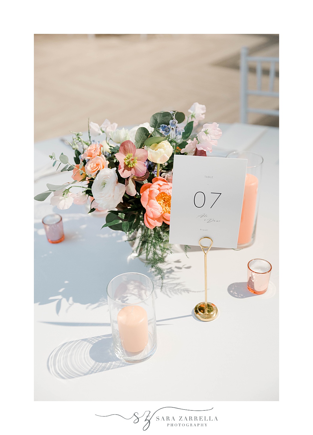 centerpieces with pink candles and gold table number cards