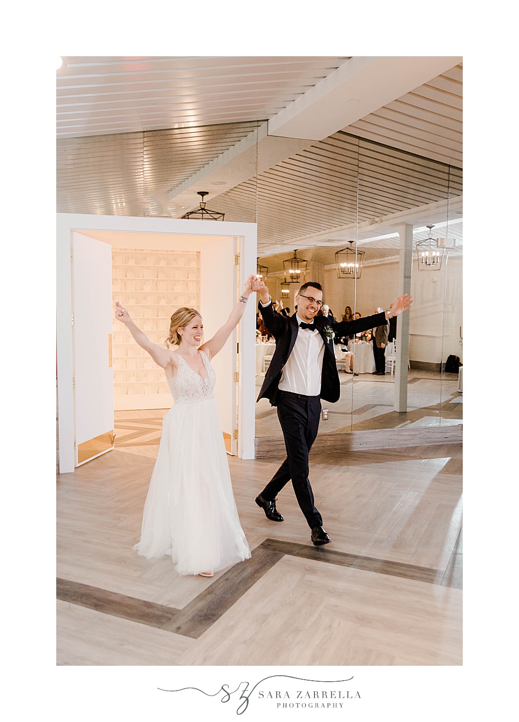 bride and groom cheer as they enter Newport RI wedding reception