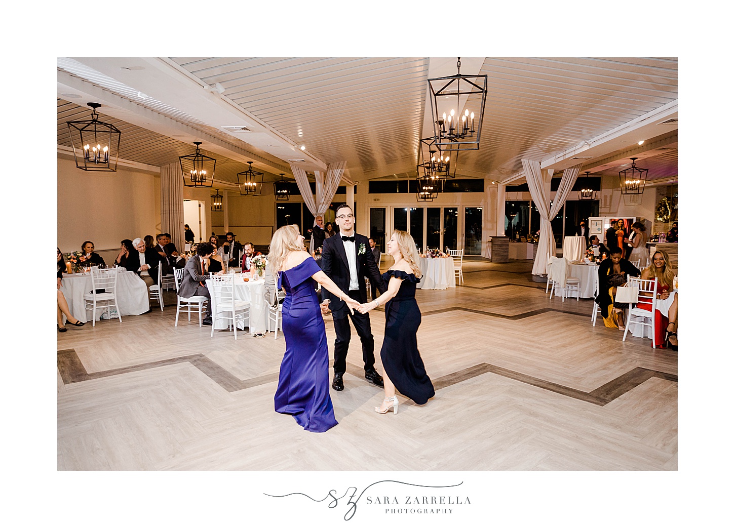 groom dances with two moms during Newport RI wedding reception