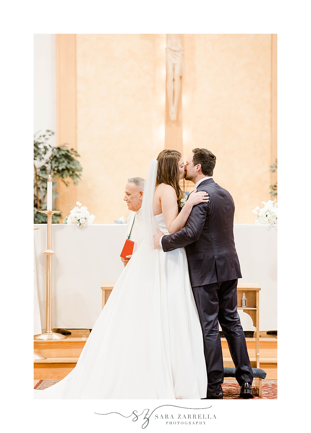 newlyweds kiss during traditional church wedding in South Kingstown RI