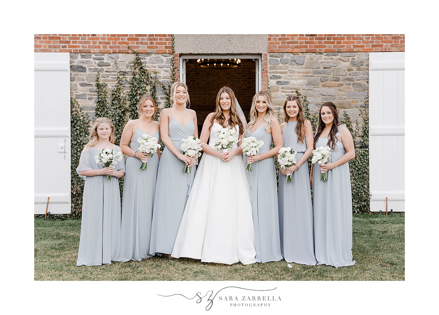 bride poses with bridesmaids in blue gowns at Shepard's Run