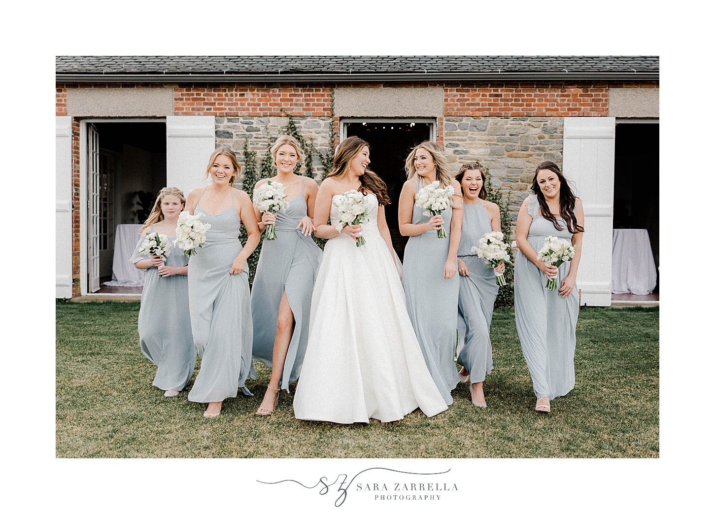 bride walks with bridesmaids in robin's blue gowns