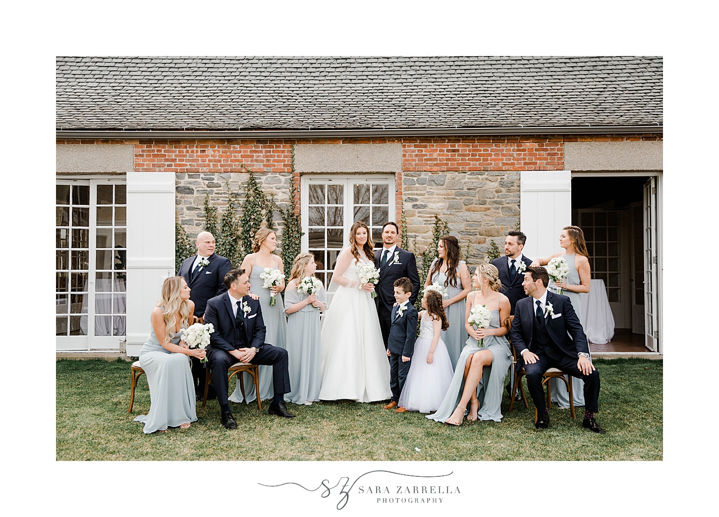 bride and groom pose with large bridal party outside Shepard's Run