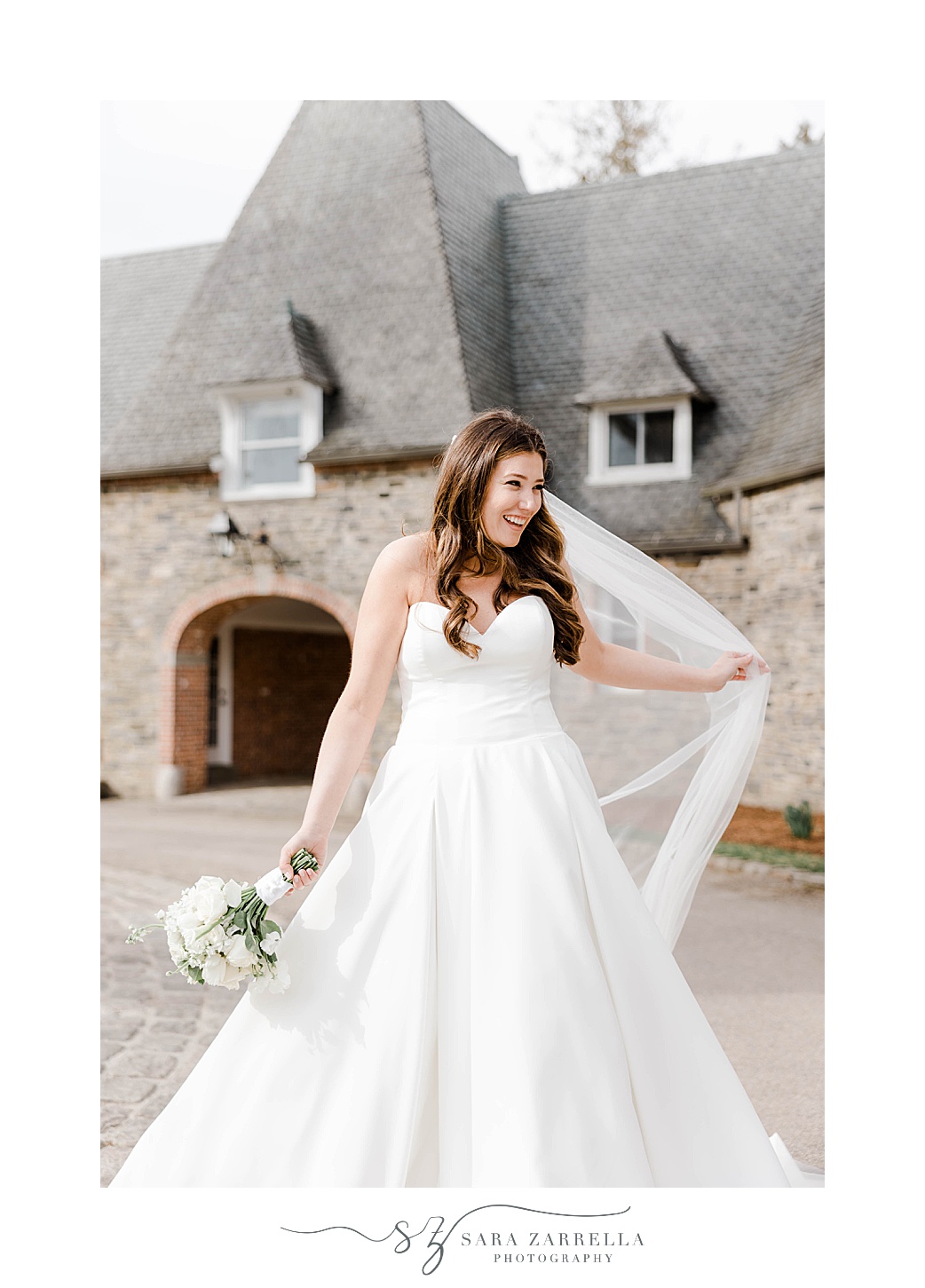 bride twirls wedding gown with veil behind her