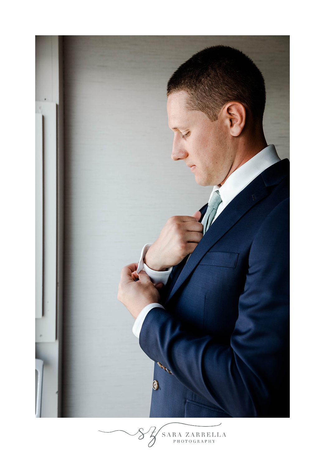 groom adjusts cufflinks before Rhode Island wedding