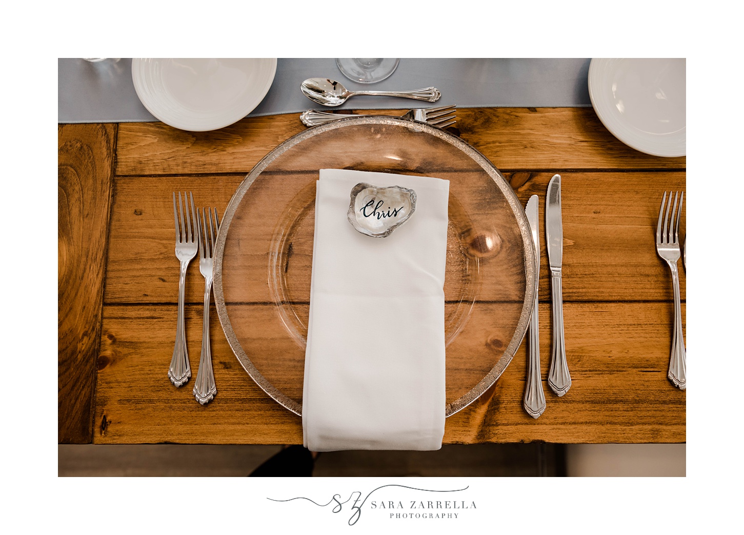 place setting on wooden table with oyster seating card