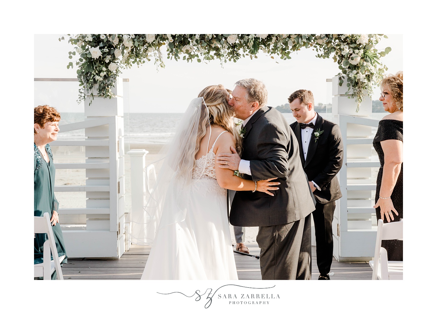 dad kisses bride's cheek during Newport Beach House wedding ceremony