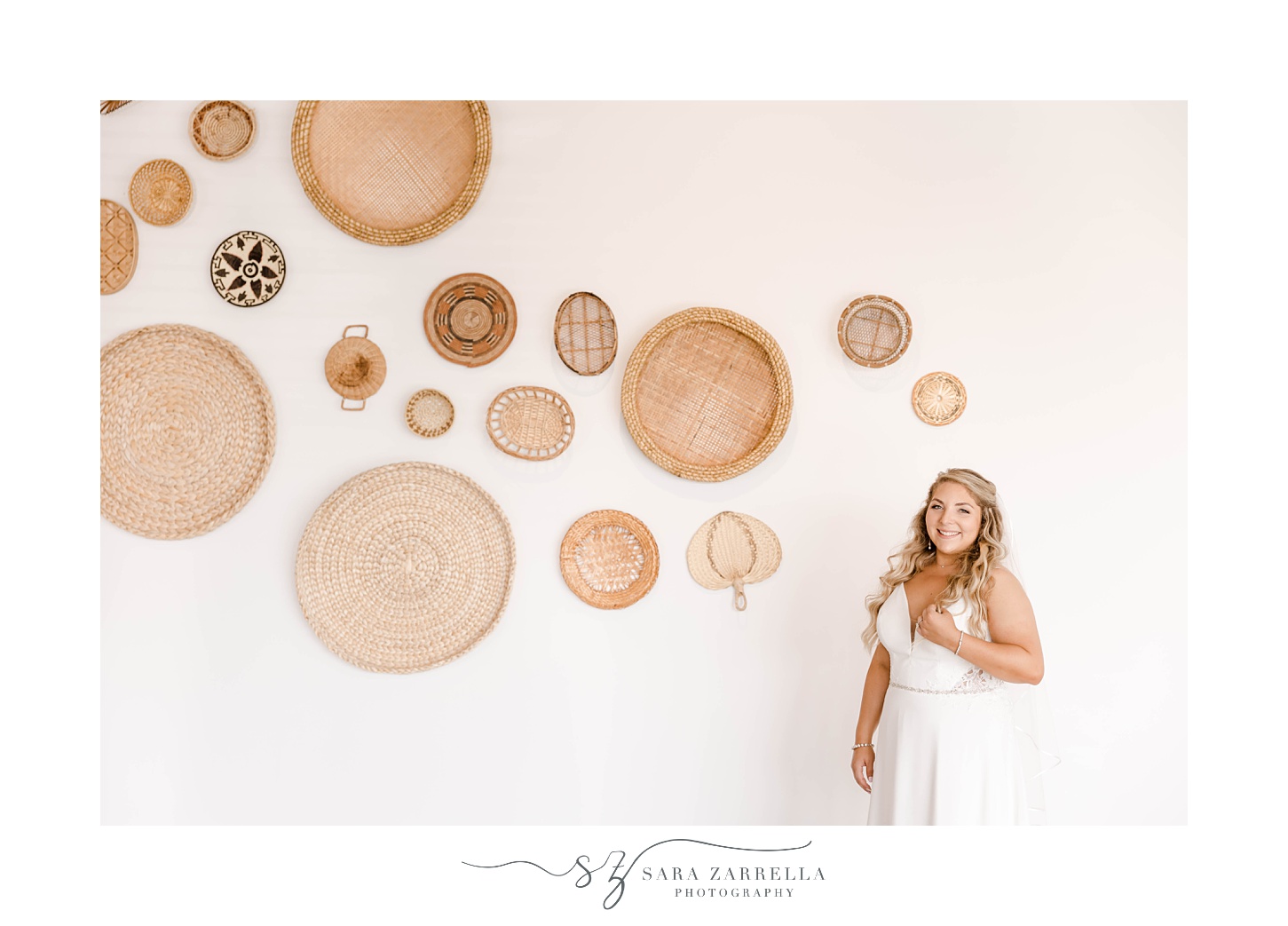 bride smiles next to baskets hanging on wall at Newport Beach House