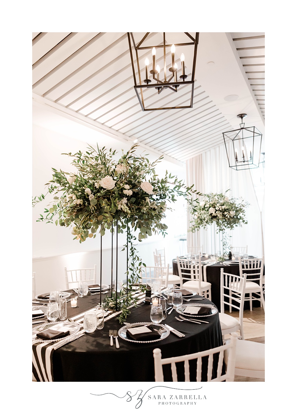 tall centerpieces with white flowers and greenery at Newport Beach House