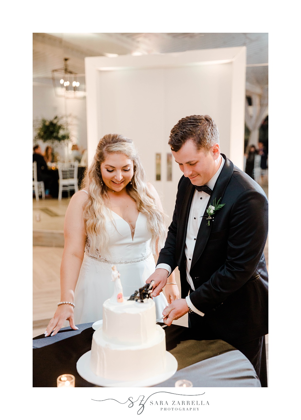 couple cuts wedding cake for RI wedding reception