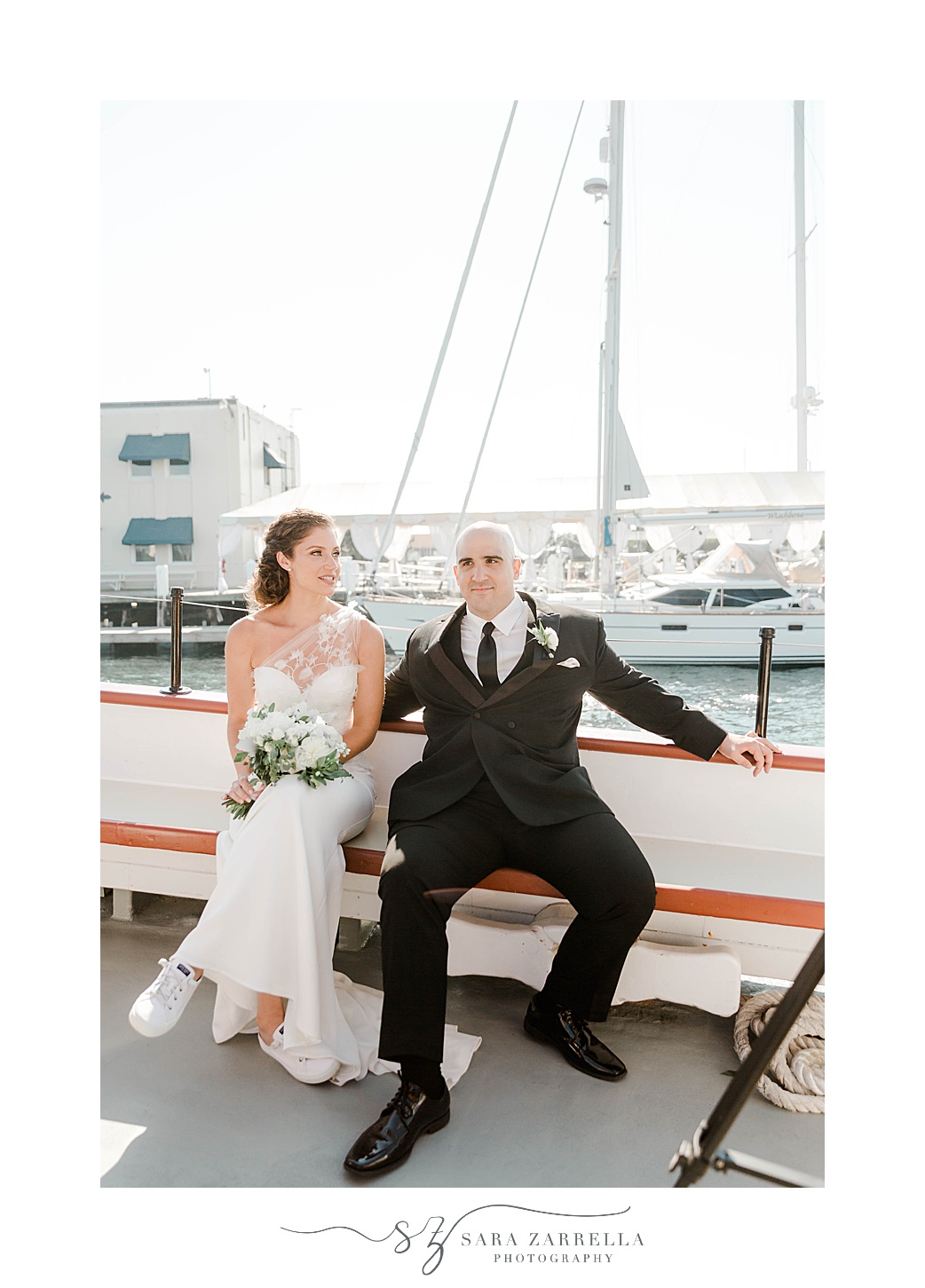 bride and groom sit on schooner Aurora