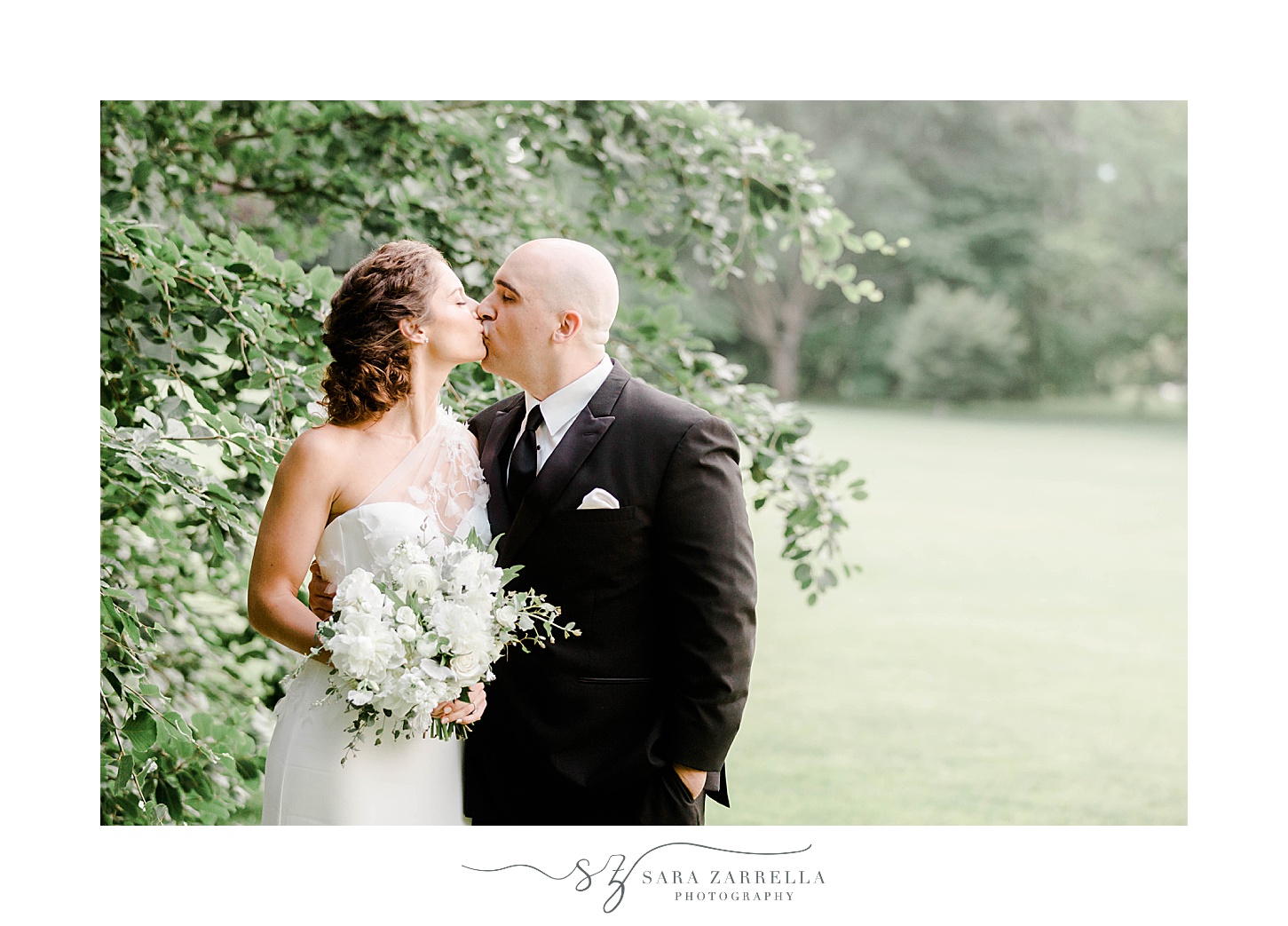 bride and groom kiss by trees at The Elms