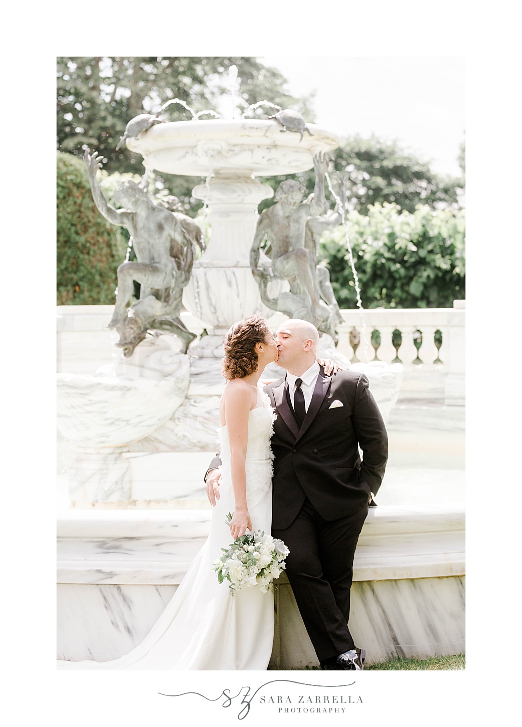 newlyweds kiss at the fountain at The Elms