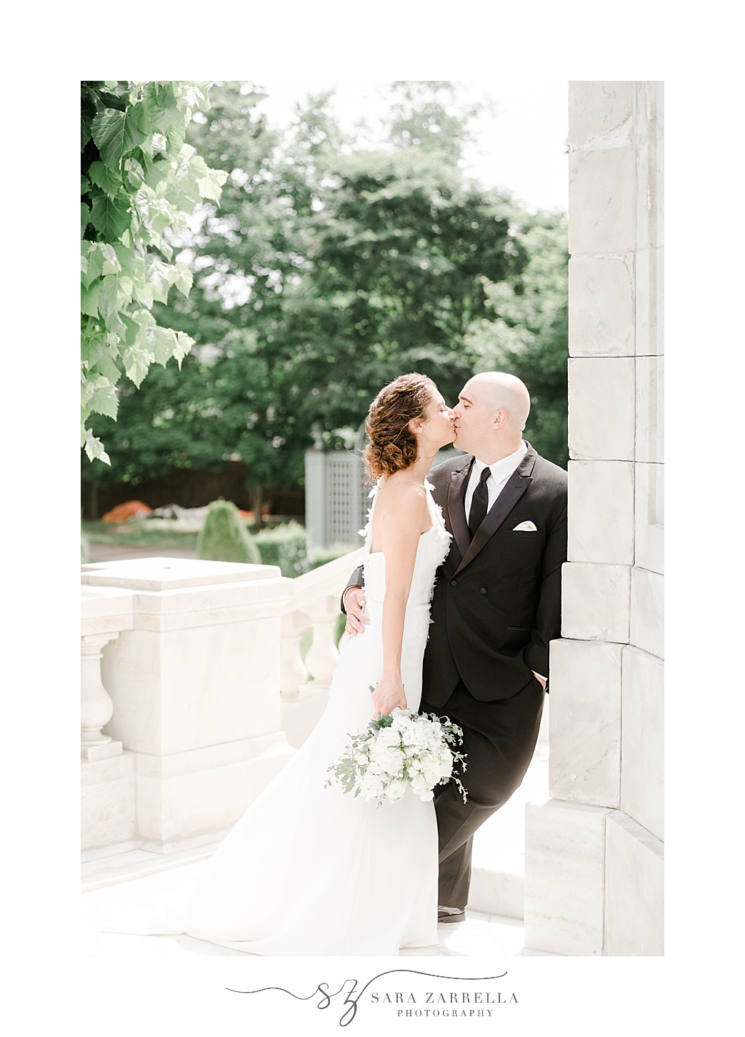 bride and groom kiss during Rhode Island wedding portraits 