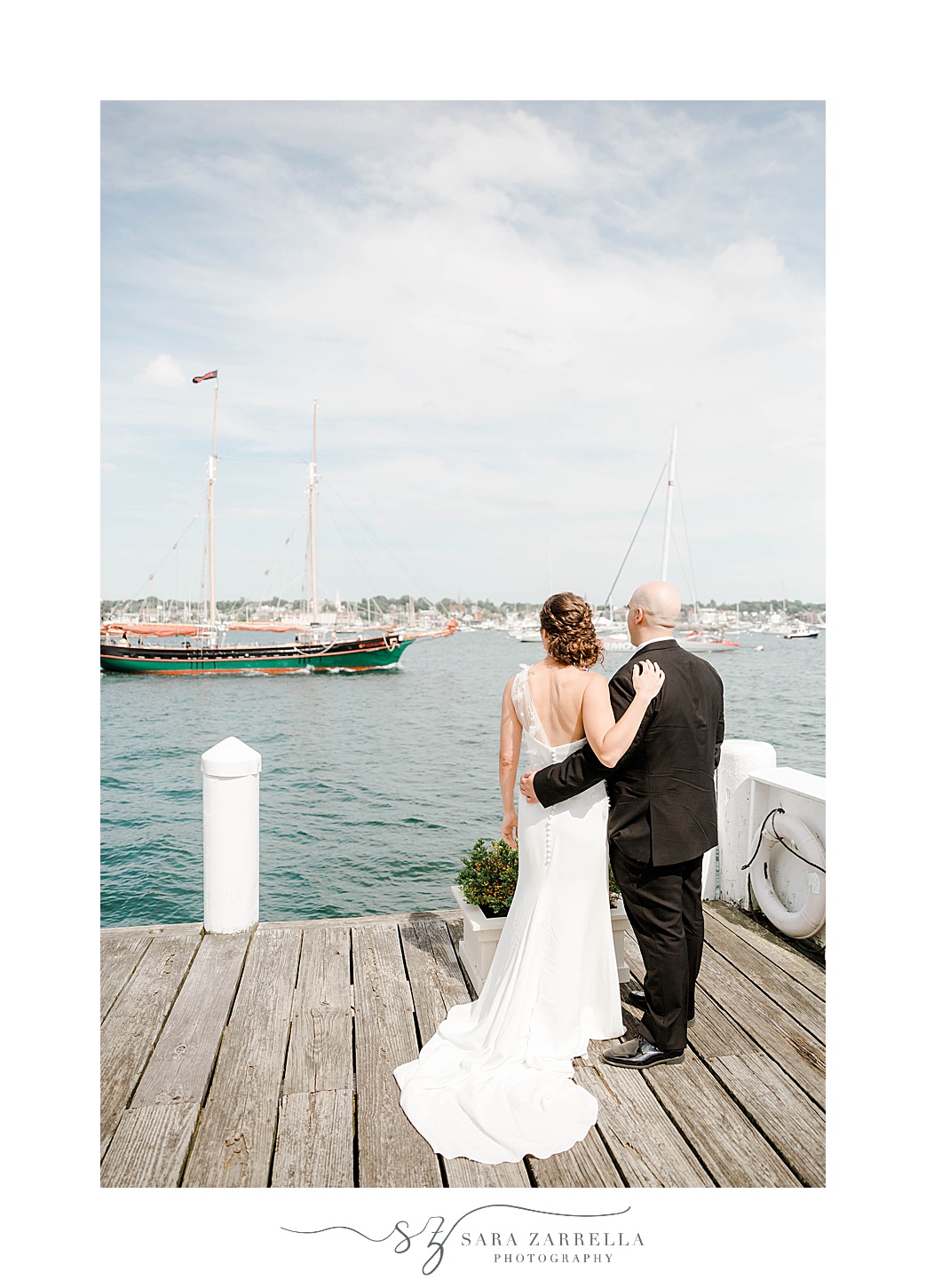 bride and groom pose on docks in Newport RI