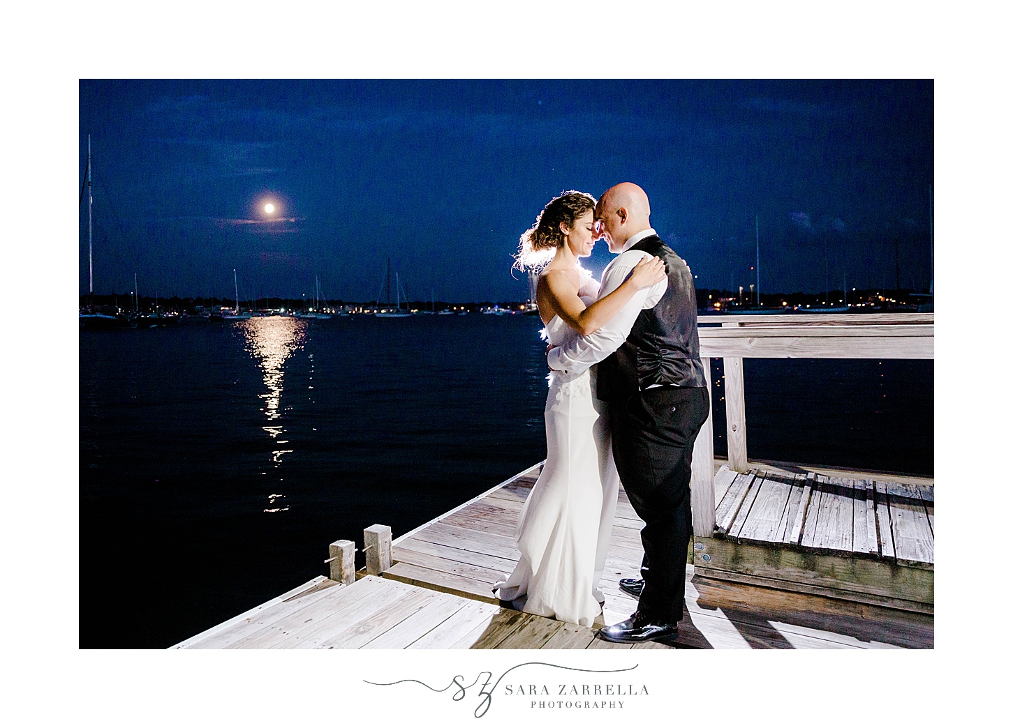 bride and groom kiss during nighttime wedding portraits in Newport RI