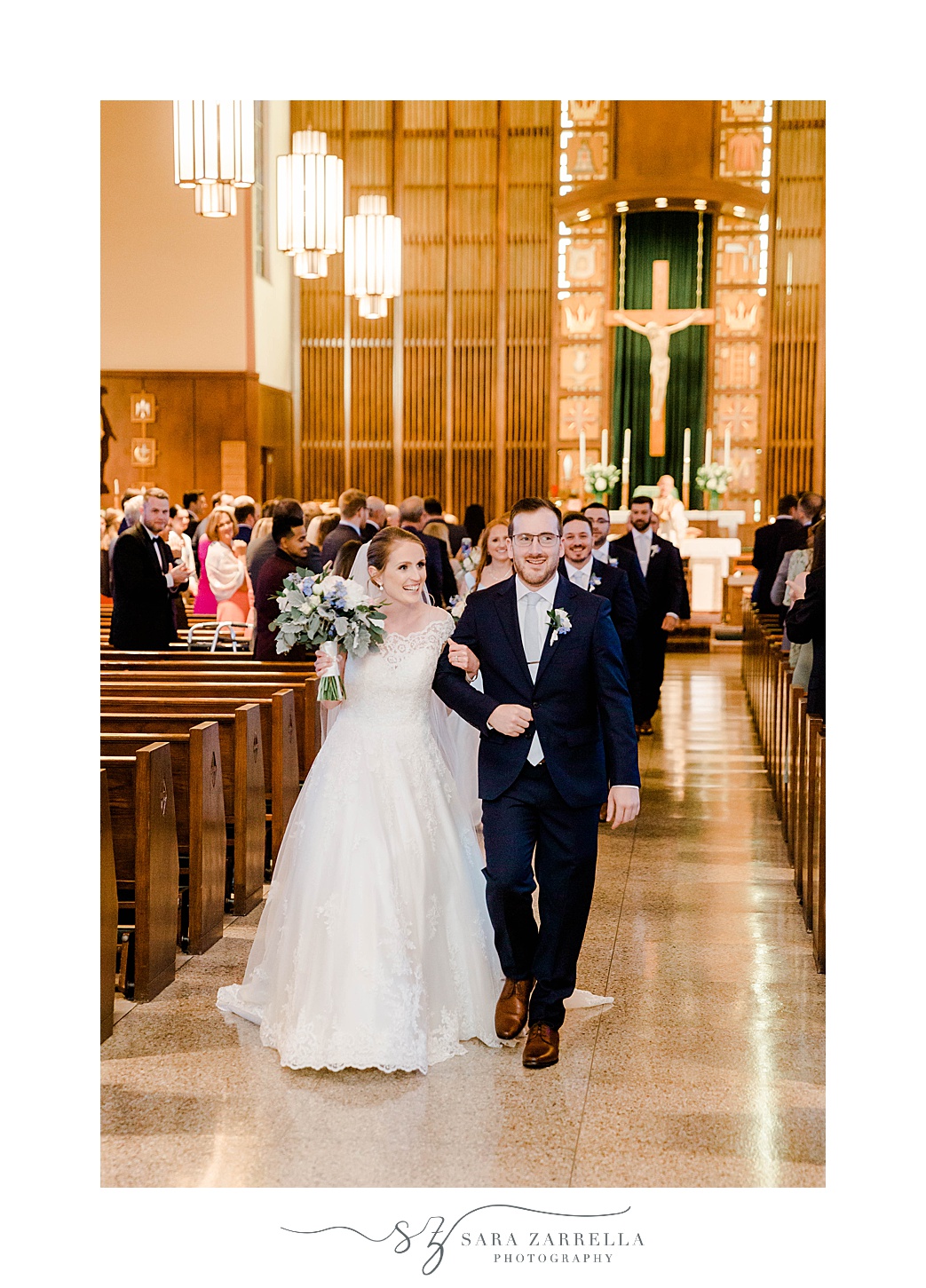 newlyweds walk up aisle after traditional wedding ceremony in Rhode Island