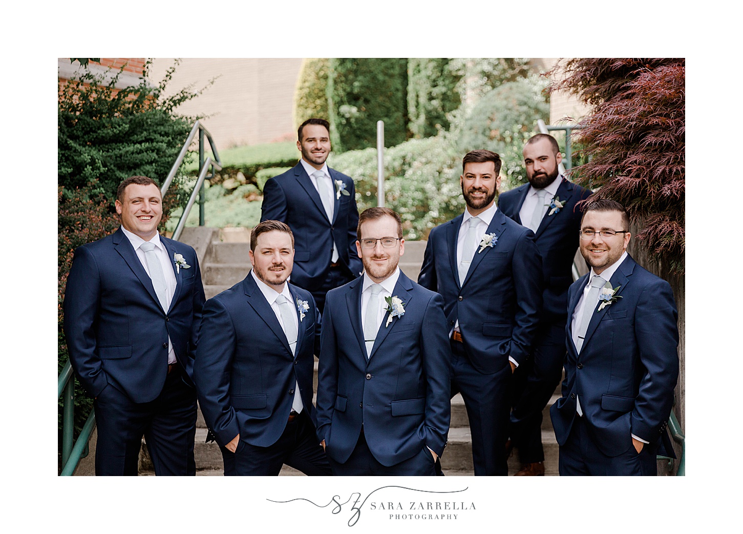 groom and groomsmen stand in navy suits outside Squantum Association
