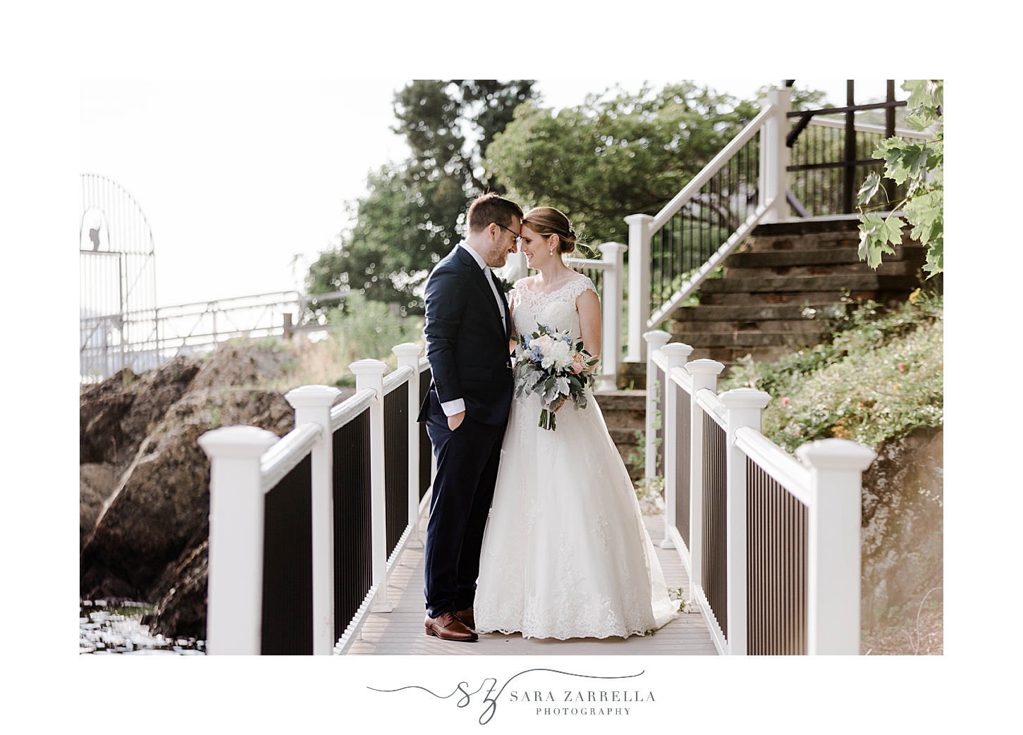 bride and groom stand on wooden bridge at Squantum Association