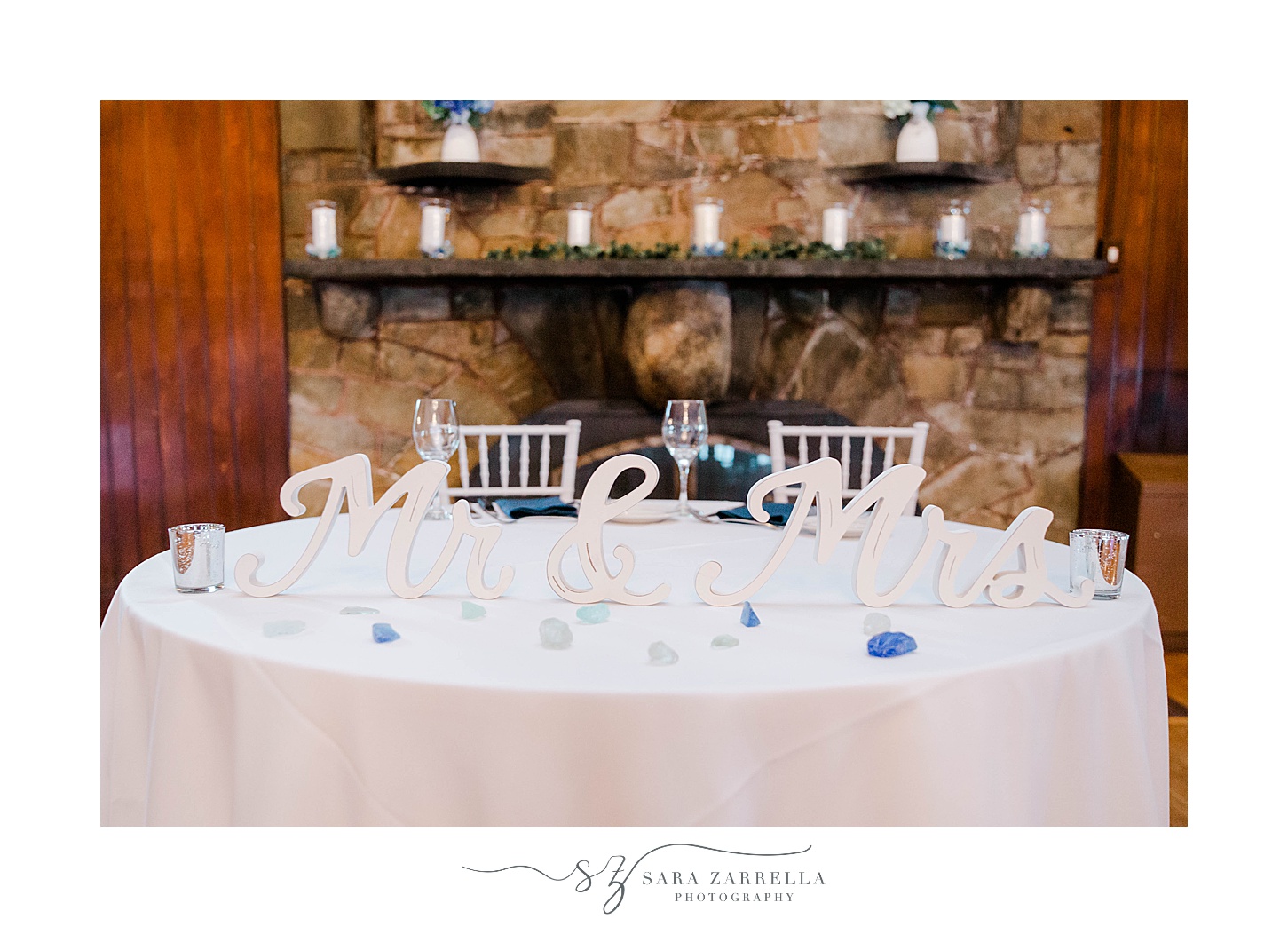 sweetheart table in front of stone fireplace at Squantum Association