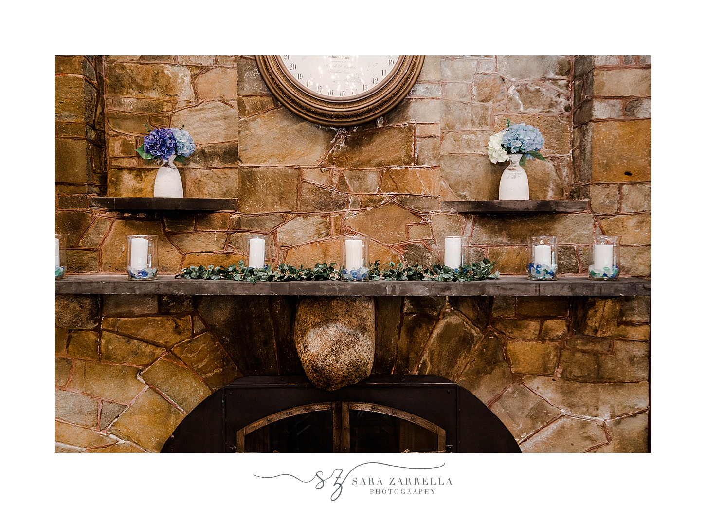 stone fireplace with white candles